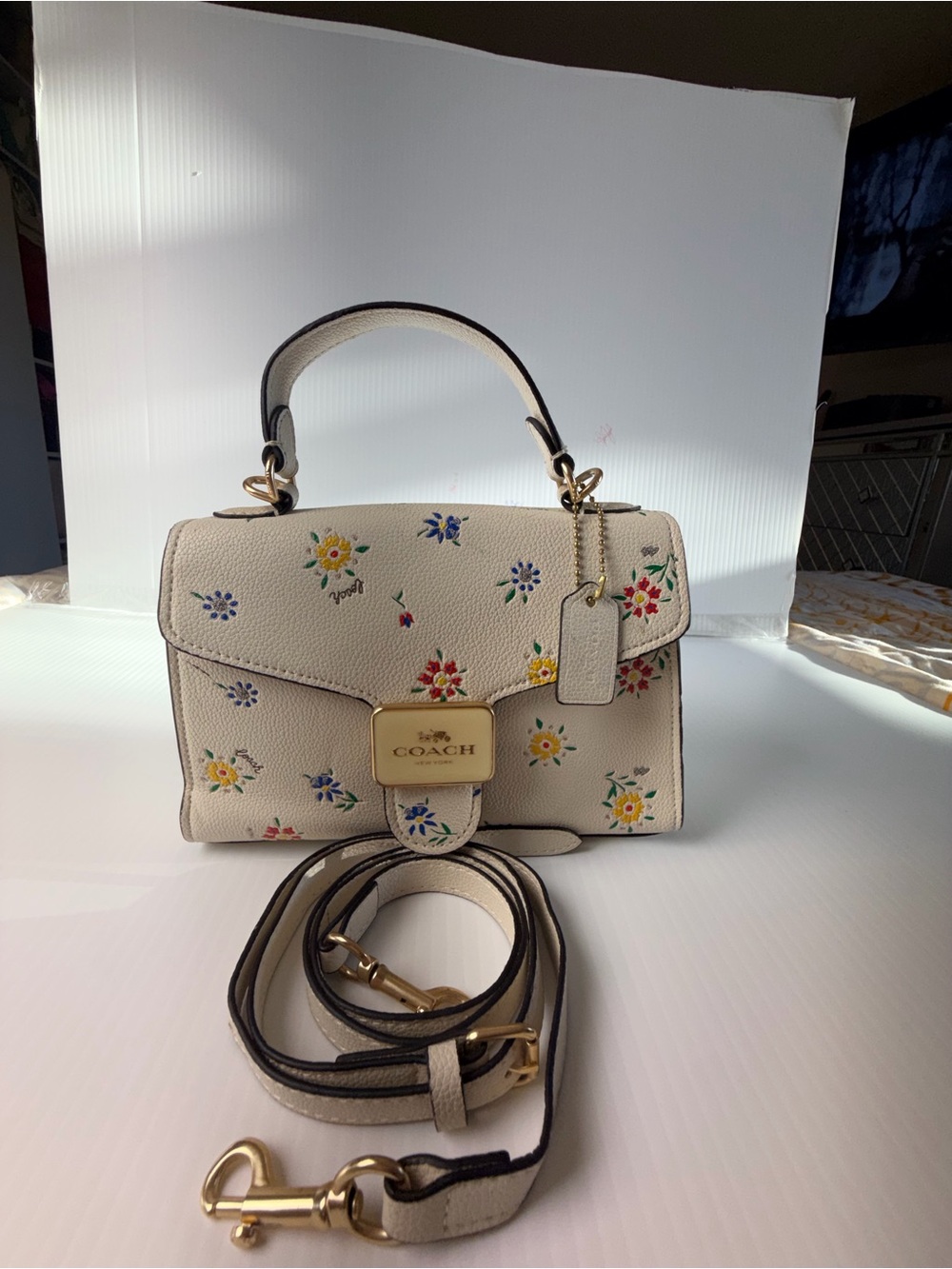 Coach Pepper Satchel in White with a floral print.